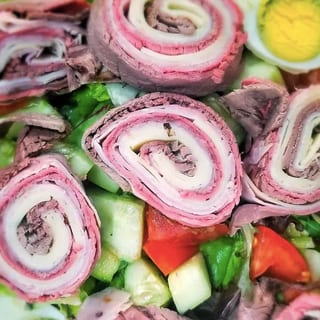 31s. Chef's Salad over mixed greens boiled eggs tomato cucumbers ham-turkey-swiss-roast beef