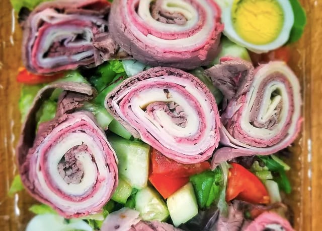31s. Chef's Salad over mixed greens boiled eggs tomato cucumbers ham-turkey-swiss-roast beef.